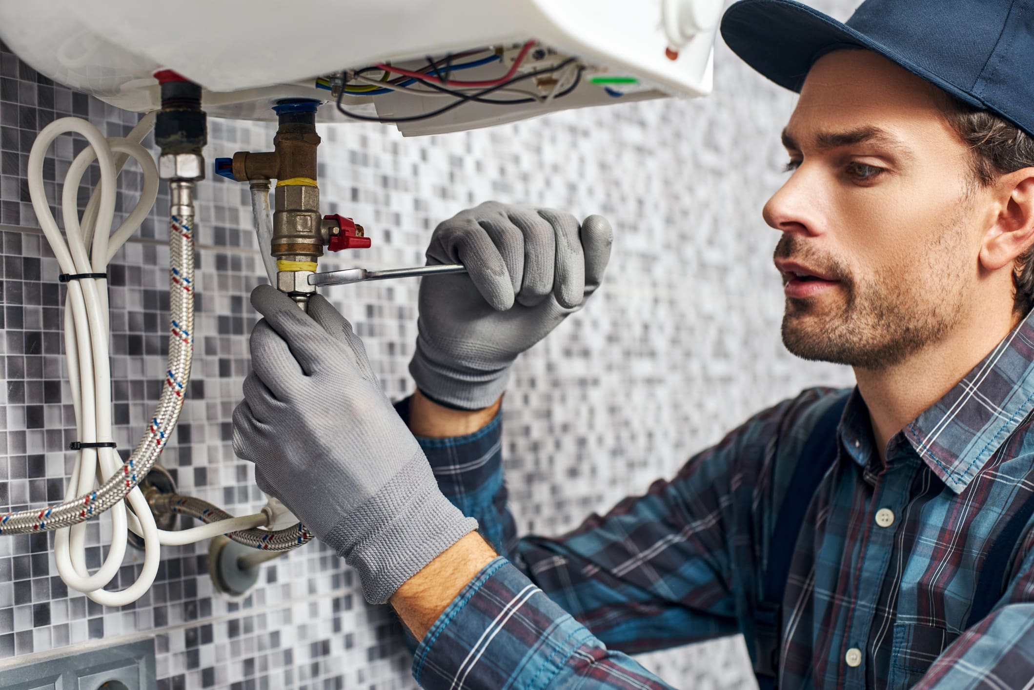 Plumber fixing a pipe with a wrench